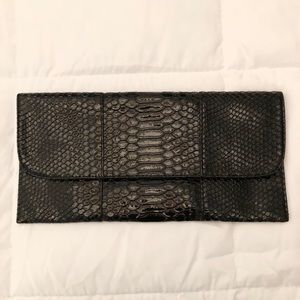 Black, snake skin textured clutch.
